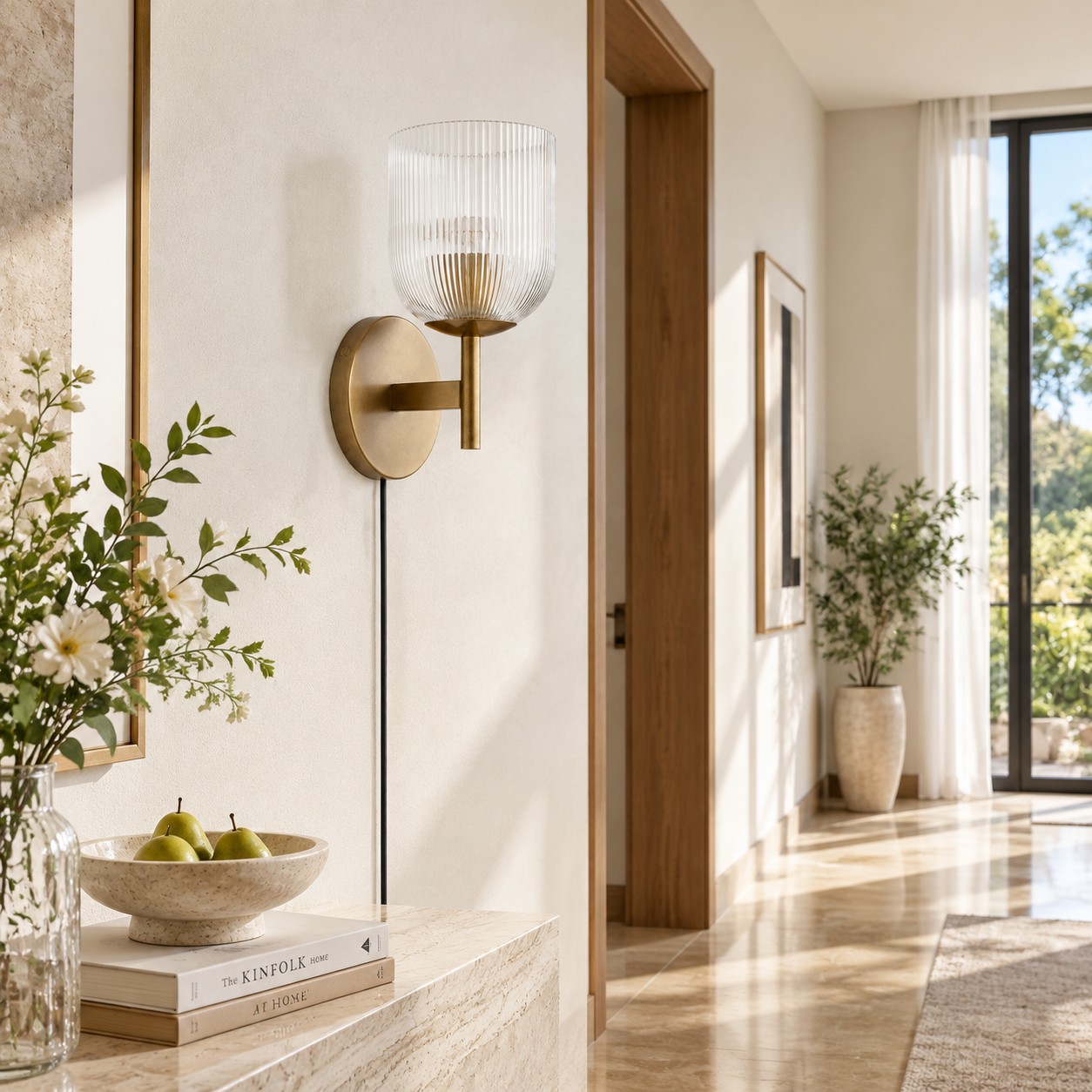 Tumbled-brass ribbed-glass sconce in a plaster hallway