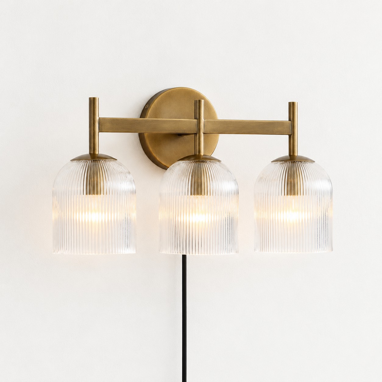 Tumbled brass ribbed-glass wall sconce, three lights